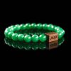 Handmade green aventurine beaded bracelet with a dark wood engraved 'JASE' logo block, shown on a reflective black surface.
